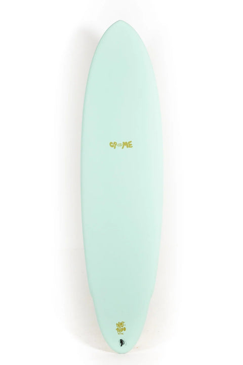 A mint green surfboard with gold foil 'OF ME' lettering and a small gold flower emblem near the tail, shown vertically against a plain white background.